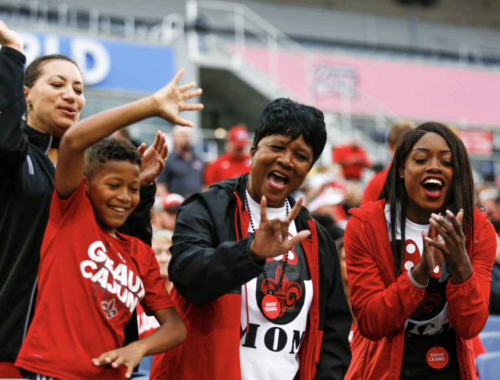 Four Ragin Cajun fans cheer on their team